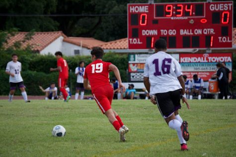 Junior Jesus Sandoval running with the ball after dribbling past the opposing team’s midfielder.