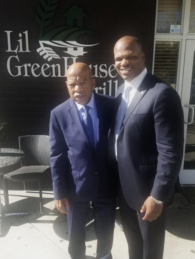 Dixon smiles for a picture with the late John Lewis, a former United States Representative who was known for his activism during the Civil Rights Movement. 