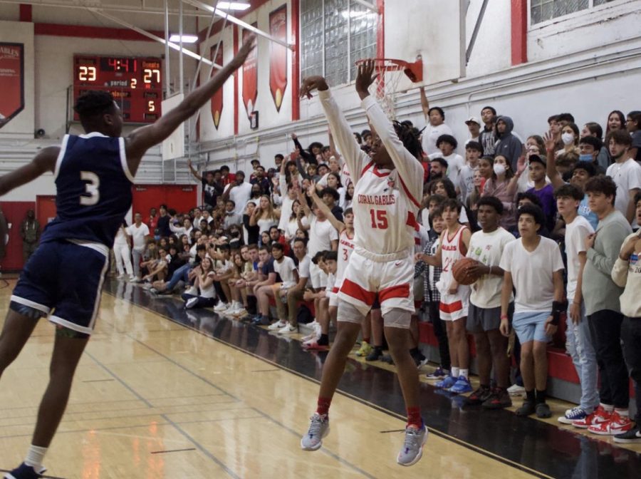 Freshman Nehemiah "Boopie" Daniels shooting a basket against the Miami High Stingarees.
