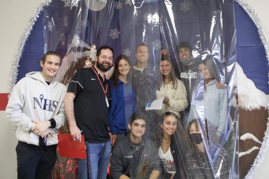 Student judges and Principal Ullivarri posing inside the life-sized snow globe created by Ms Leal-Garcia, the first place winner.