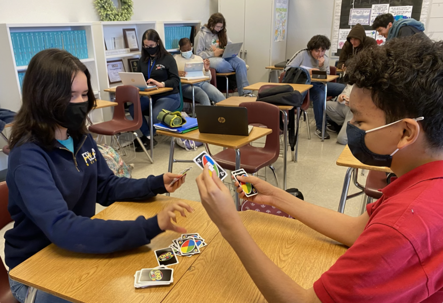Two students try out "Uno All Wild" for the first time.