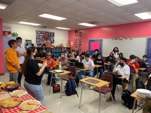 FHS members listen to their monthly presentation on French culture before eating crepes.