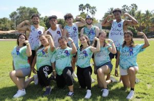 The Goal Diggers flexing their muscles after their tug of war tournament win.