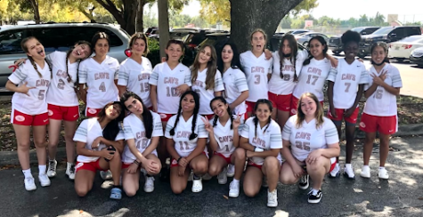 The girls flag football team moments before the game after spending several hours practicing with the help of Victoria Mavarez (left to right: fourth on bottom row) and Lea Bergeot (fifth on bottom row).