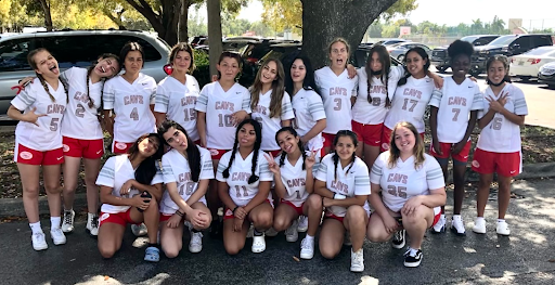 The girls flag football team moments before the game after spending several hours practicing with the help of Victoria Mavarez (left to right: fourth on bottom row) and Lea Bergeot (fifth on bottom row).