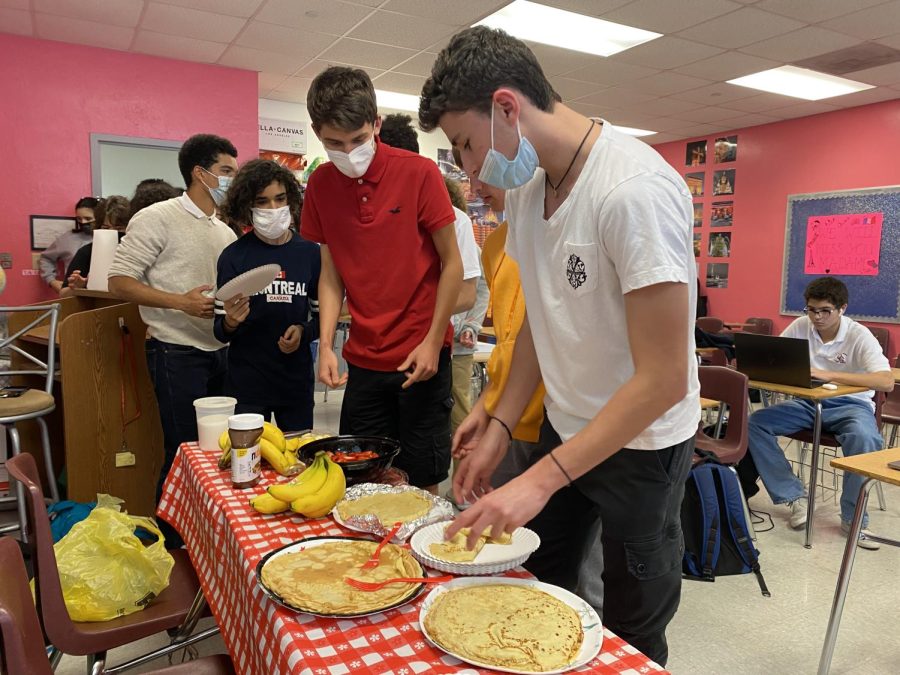 Members of the French Honor Society line up to be served a crepe in celebration of a French tradition, the Chandeleur.
