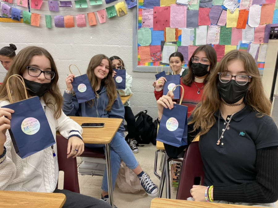 Students at Ana Maestre’s Interact meeting showing off their newly made candles.