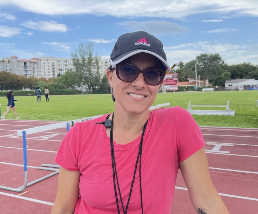 Coach Jennifer Chapman stands in front of the Gables track before a meet.