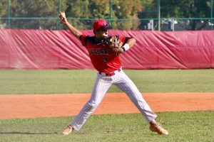 The current third baseman for the varsity crew, Morina winds up to throw a baseball into the first baseman’s glove.