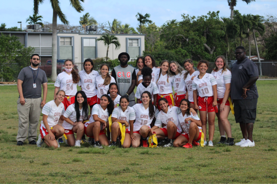 The+girls+flag+football+team+joined+by+their+coaches+Coach+Strachan+and+Coach+Willy.