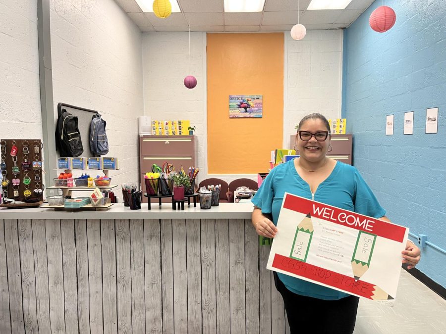 SPED Department teacher Mrs. Feeney stands beside Gables' newest store: CavShop.