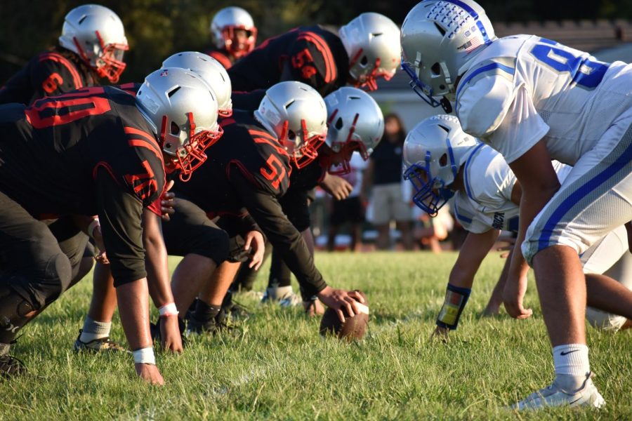 Cavalier players decked out in red and black prepare to make the first play of the game. 