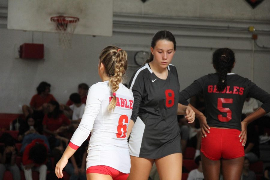 Varsity players exchange high-fives before adjusting for a new set. 