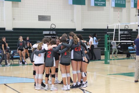 The girl's volleyball team huddles up before their game against Ransom Everglades High school.