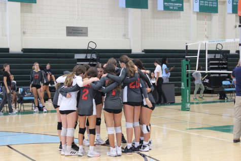 The girls volleyball team huddles up before their game against Ransom Everglades High school.