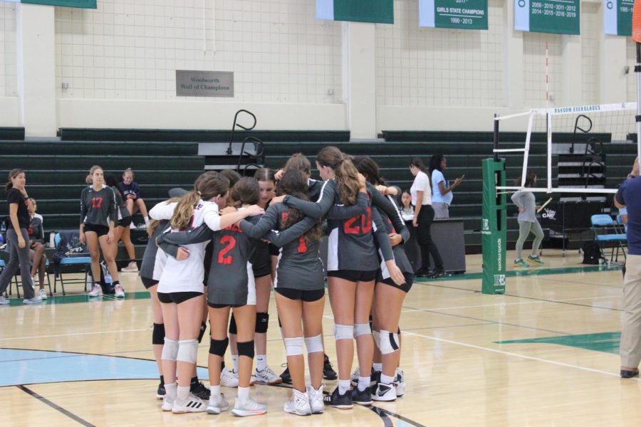 The girls volleyball team huddles up before their game against Ransom Everglades High school.