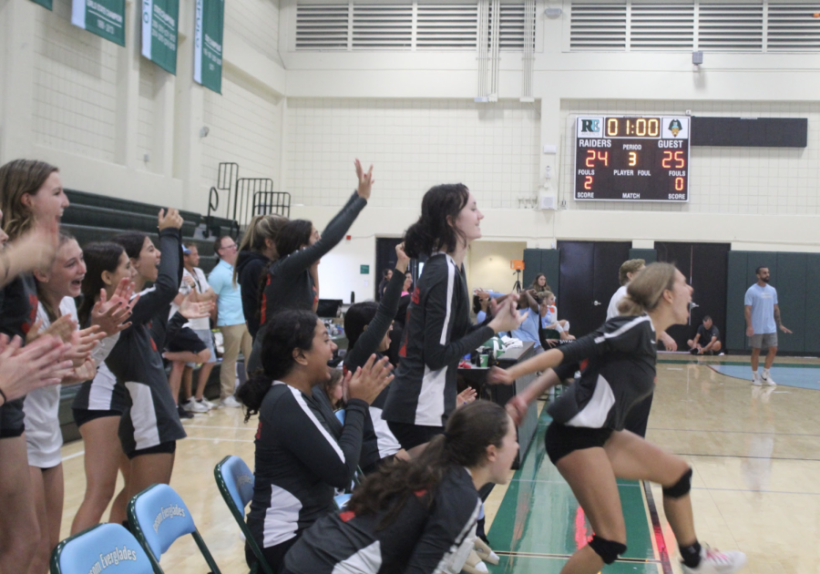 The Girls Volleyball Team rejoicing as their team scores a point.
