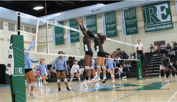 Senior Celina Richardson and freshman Bianca Benson leap sky high to attempt a block. 