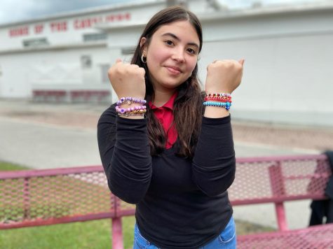 Dainelys Ledesma shows off some of her recent creations for her small business DD's Jewelry.