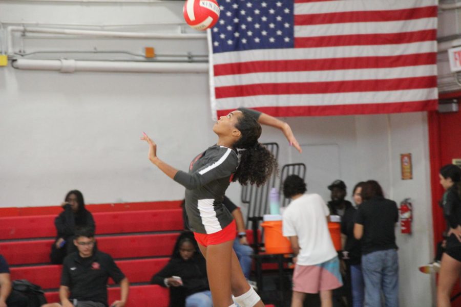 Avery Felix serves the ball, aiming at an ace point for Gables Varsity volleyball team.