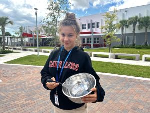 Sophomore Paloma Rosania smiling as she begins to prep for the start of her organization "Food 4 Thought."