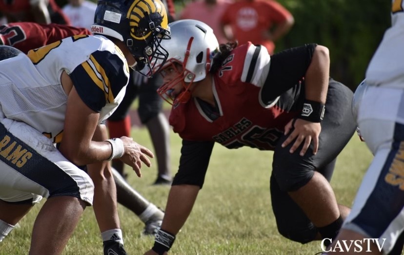 Imposing fear with his stance, senior Reynaldo Gimenez (right) gets ready to penetrate at the line of scrimmage. 