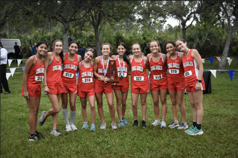 The+girls+cross+country+team+poses+with+their+District+Runner-Up+trophy.