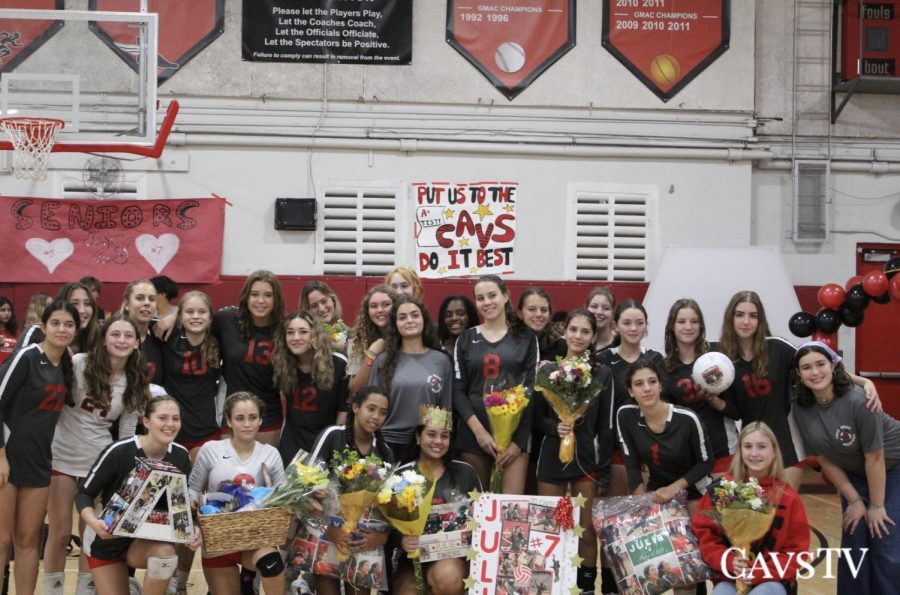 The team takes a group picture after celebrating a successful season.