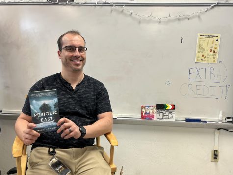 Mr. Rodríguez after a long-awaited time proudly holds the first copy of his book “Periodic East”.