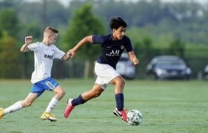 Freshman Hugo Lara dribbles the ball up field to pass to his teammates in order to score a goal.