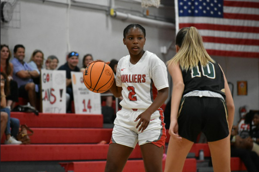 Basketball player Taylor Ravello competed in the girls varsity basketball match against the Coral Reef Cudas.