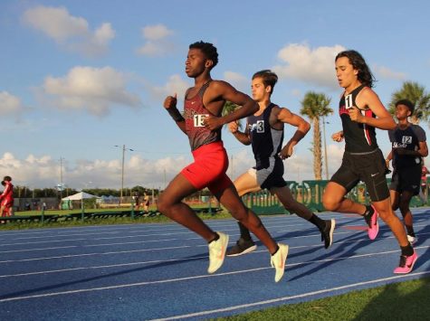 Junior Ahmad Fambro opens his strides during the 800 meter race at Traz Powell Stadium.