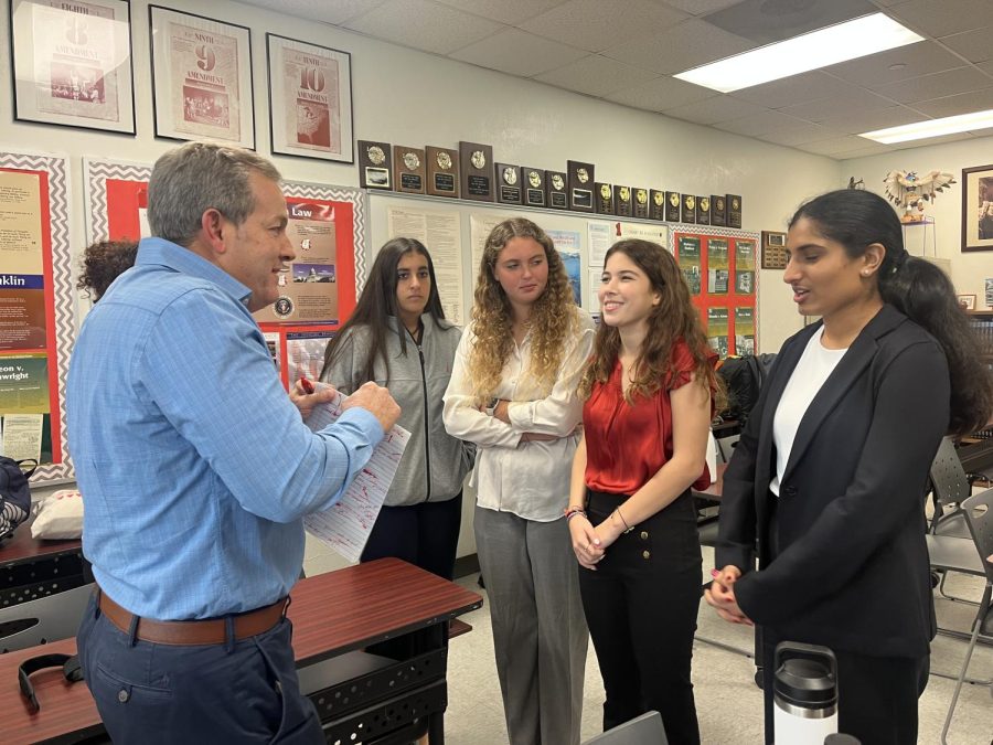 The Gables mock trial team carefully reviewing the judges critique in order to prepare for their upcoming competition.