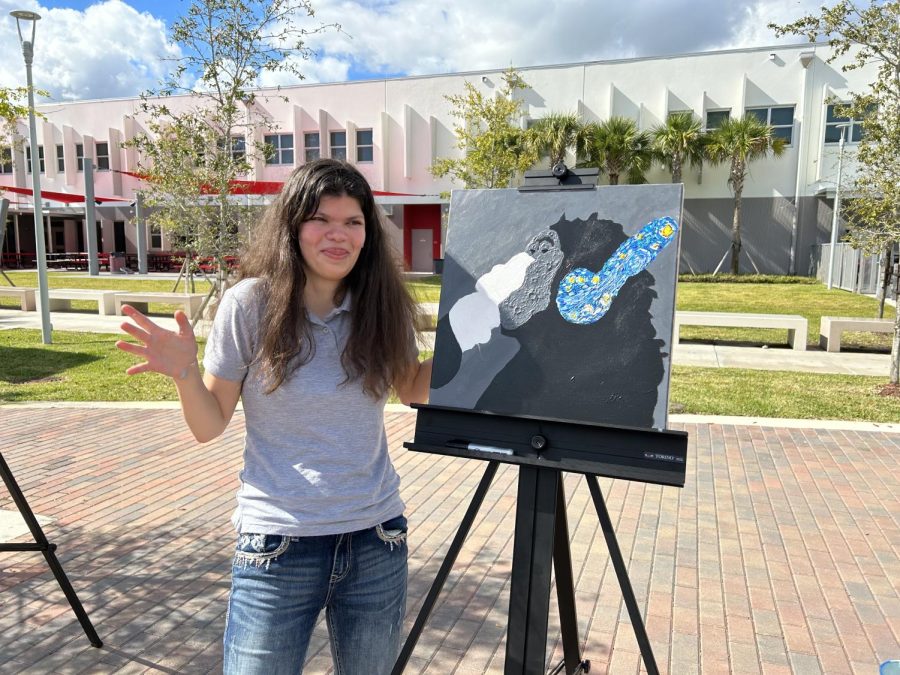 Sophomore, Sofia Perez stands proudly by her piece at the midpoint of Art Walk.
