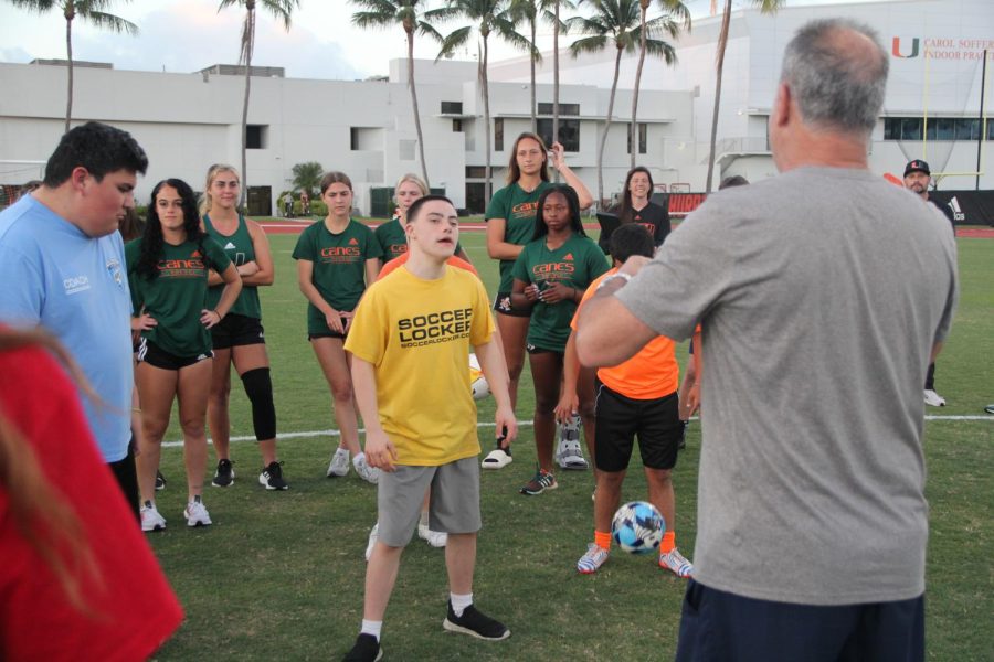 Kicking off the first winter clinics of soccer, Mr. Paz began giving instructions to the UMs womens soccer team and to Down syndrome individuals on what events are stored for them.
