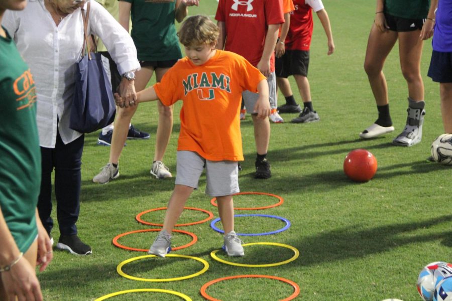 After a series of juggling a soccer ball between their legs, there were different activity sections all throughout the field including this hula-hoop crossing obstacle, where individuals go through each one.