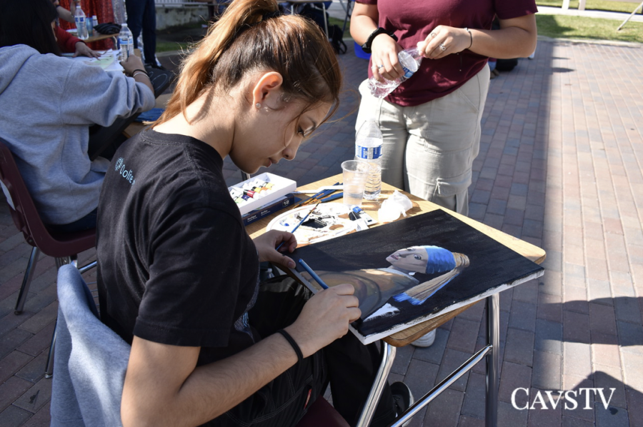 Senior, Domenika Solis paints her rendition of "Girl with a Pearl Earring" during Art Walk 2023.