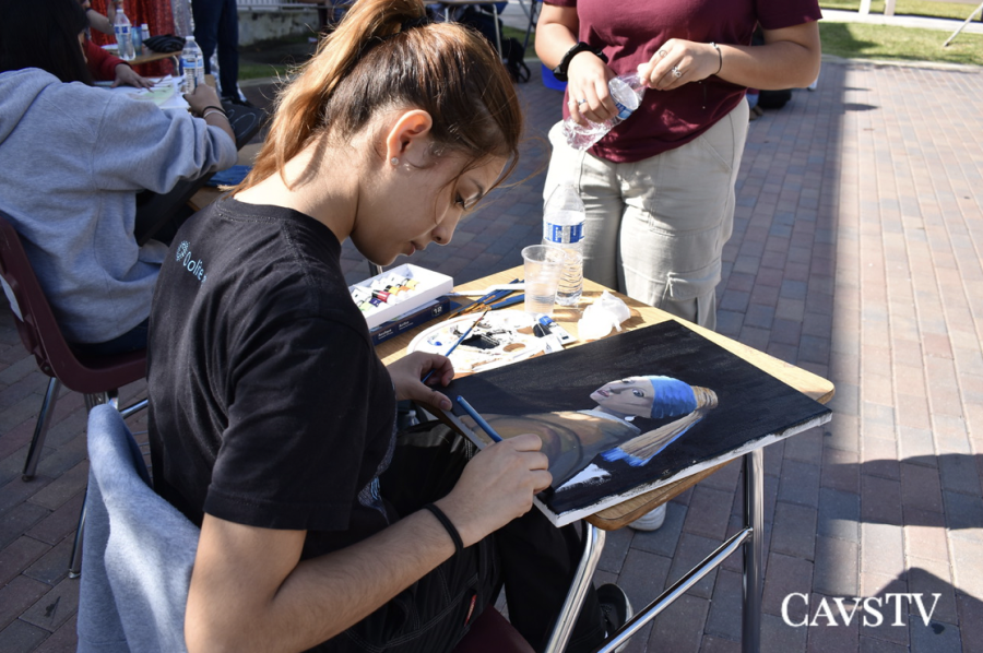 Senior, Domenika Solis paints her rendition of Girl with a Pearl Earring during Art Walk 2023.