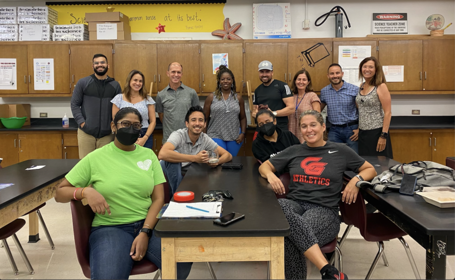 Mrs. Phillips (center) stands proudly with her colleagues from the science department.