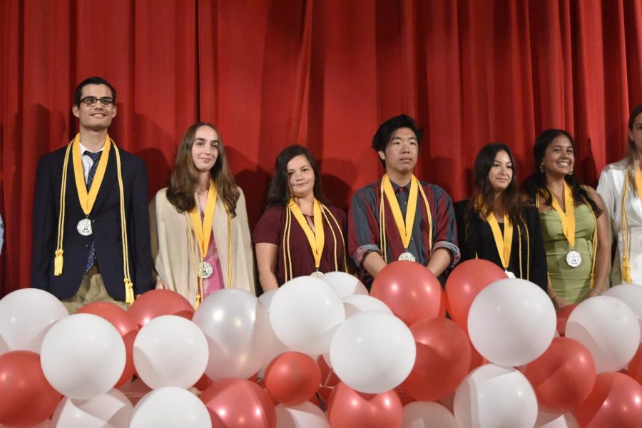 Class of 2023 Summa Cum Laude seniors smile proudly at their last Awards Ceremony, ready to face their graduation wearing their hard-earned chords and medals. 