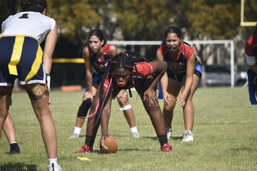 As the referee blows the whistle, quarterback Hannah Pascul-Florez signals for her center to snap back the ball. As the play begins, she calculates the best plan of action, throwing it to her most dependable receivers.