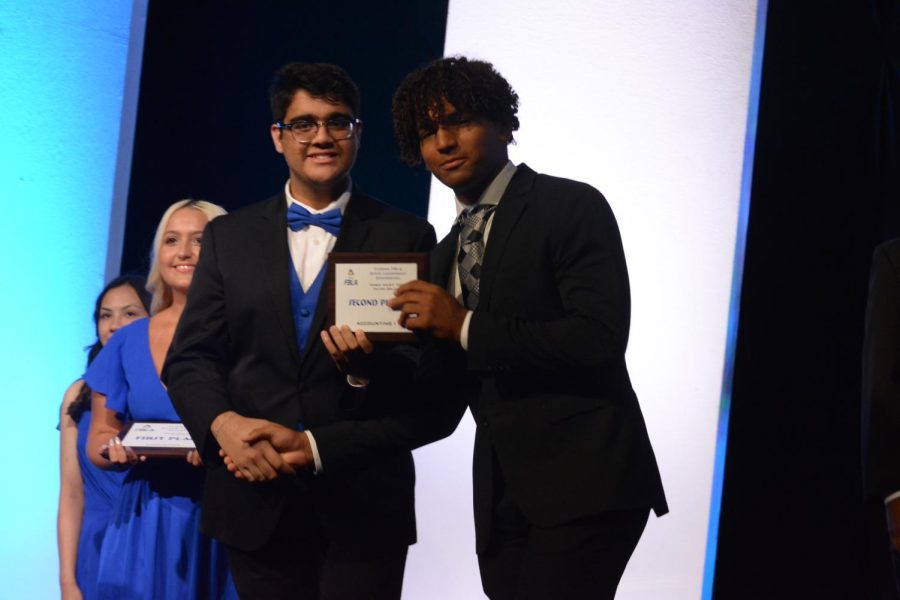 Kalel Sada shakes Aarav Dagger, state and national FBLA president, after placing second in Accounting.