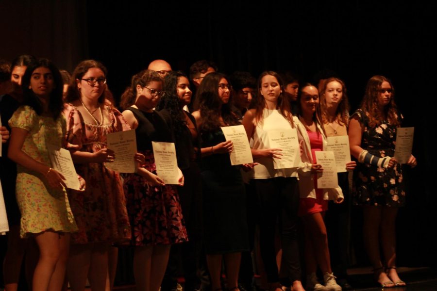 NHS inductees proudly hold their certificates for a group photo, ready to continue the prestigious clubs legacy.