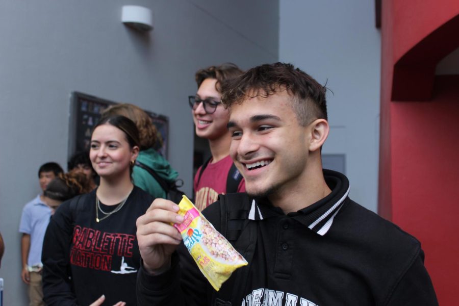 Junior Diego Imbert enjoys Dippin' Dots after school on the second week of sales.