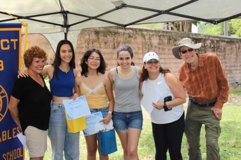 Interact 2022-23 Board members pose alongside their sponsor Ms. Depaola, remembering their years of service with the club and the positions they will pass down to next years incoming leaders. 