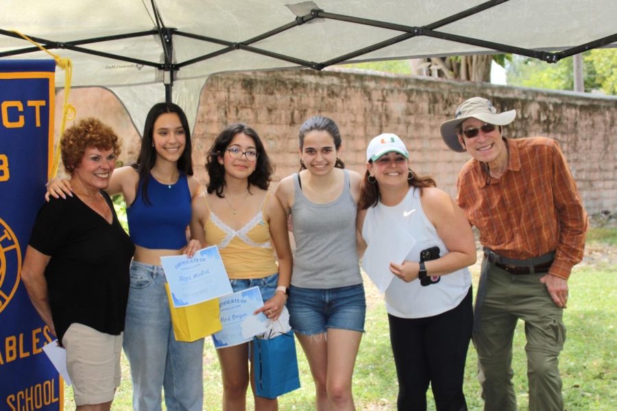 Interact 2022-23 Board members pose alongside their sponsor Ms. Depaola, remembering their years of service with the club and the positions they will pass down to next years incoming leaders. 