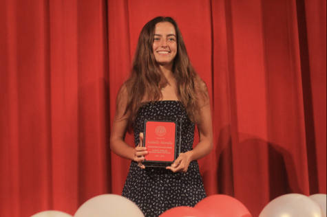 Senior Isabella Morales stands proudly with the Outstanding Athlete award she received during the awards ceremony.