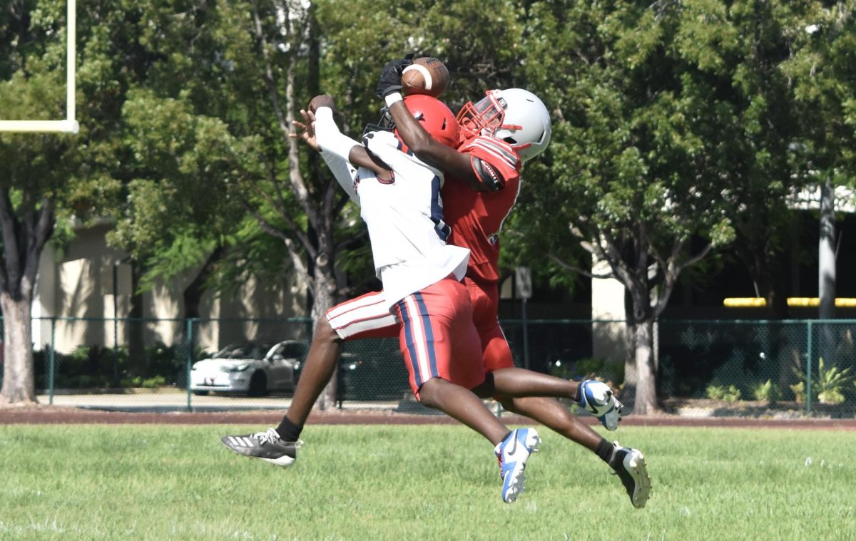 Attempting to get the ball in every possible way, both varsity opponents try to reach the football in determining scoring