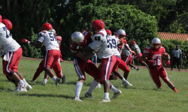 Eyeing every inch of the field, both the Cavaliers and the Patriots defend fiercely as the game reaches half-time.