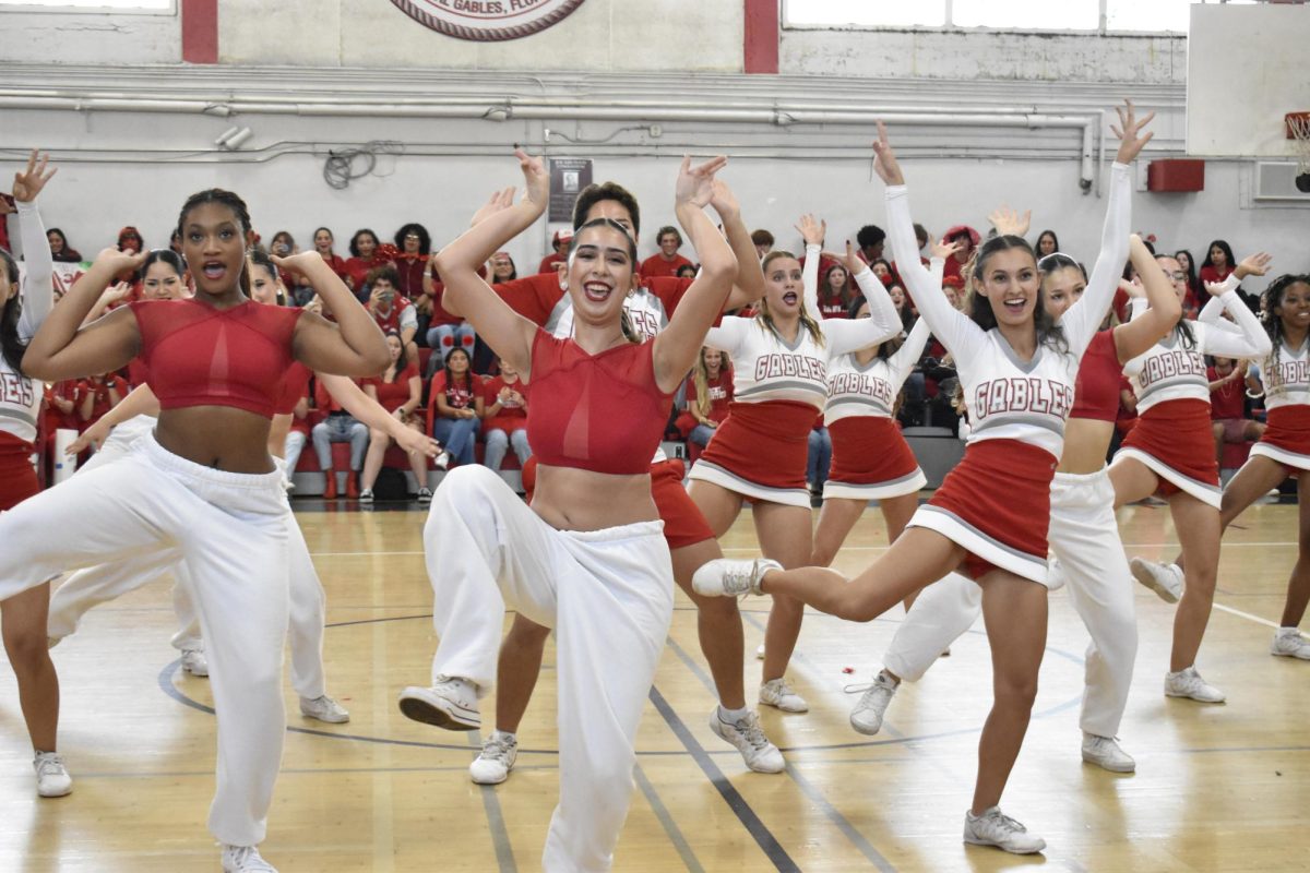 Dancing side by side, the Gablettes and the cheerleaders successfully execute their routine, wowing the surprised crowd. 